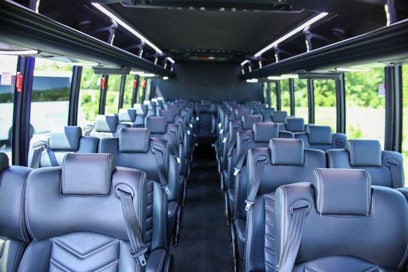 modern-white-41-passenger-mini-bus-interior-seats-full-front-view-day-light