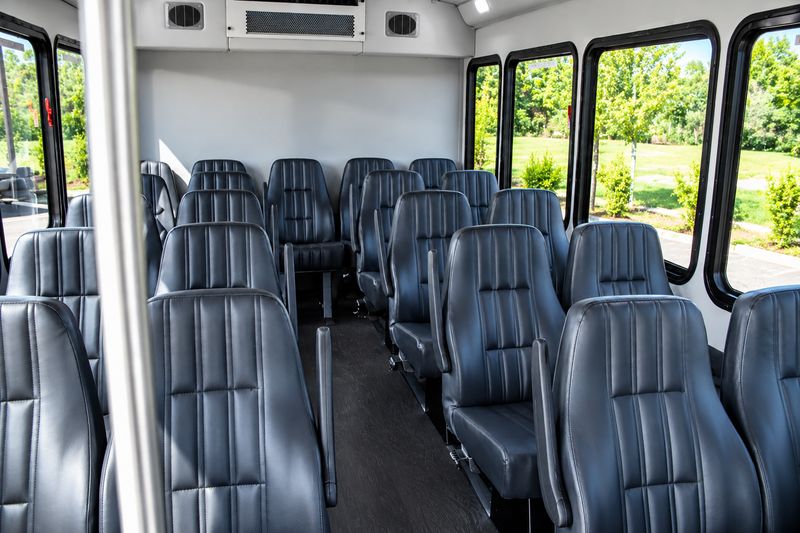 modern-white-shuttle-bus-interior-21-passenger-front-view-seating