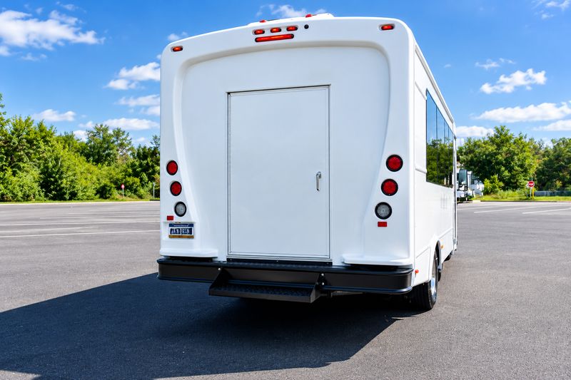 21-passenger-white-mini-bus-shuttle-exterior-rear-view-luggage-compartment